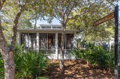 a house with a street sign in front of it at Fin and Tonic - Magnolia Cottages 3 BR, Heated Community Pool, Bikes in Inlet Beach