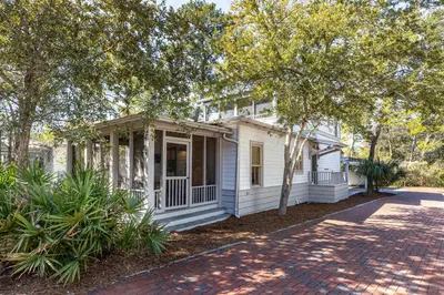 a white house with trees in front of it at Fin and Tonic - Magnolia Cottages 3 BR, Heated Community Pool, Bikes in Inlet Beach