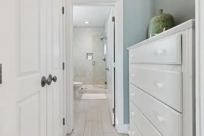 a white bathroom with a toilet and a sink at Seacrest Beach - 3 BR, Bikes, Pool & Beach in Rosemary Beach
