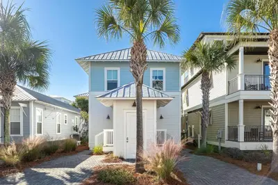 a house with palm trees in front of it at Seacrest Beach - 3 BR, Bikes, Pool & Beach in Rosemary Beach