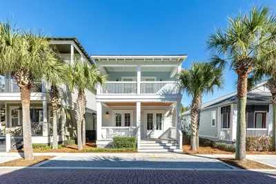 a house with palm trees in front of it at Seacrest Beach - 3 BR, Bikes, Pool & Beach in Rosemary Beach