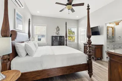 a bedroom with a bed and a ceiling fan at New Kululu WEST- 3 BR, Sleeps 11, Heated Salt Water Pool, Bikes & moments from the beach in Santa Rosa Beach