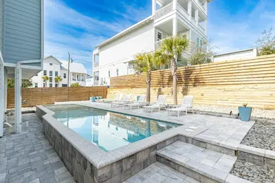a swimming pool in the backyard of a house at New Kululu WEST- 3 BR, Sleeps 11, Heated Salt Water Pool, Bikes & moments from the beach in Santa Rosa Beach