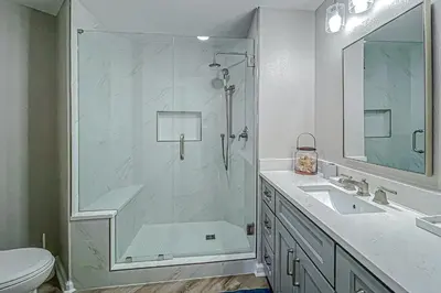a bathroom with a shower and a sink at Beautifully decorated oceanfront condo with resort pool & huge walk-in showers in Santa Rosa Beach