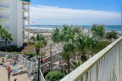 a view of the beach from the balcony of a resort at Beautifully decorated oceanfront condo with resort pool & huge walk-in showers in Santa Rosa Beach