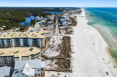 an aerial view of a beach with condos at Beautifully decorated oceanfront condo with resort pool & huge walk-in showers in Santa Rosa Beach