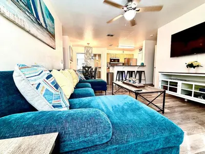 a living room with two blue couches and a tv at Bexley Blue in Panama City Beach