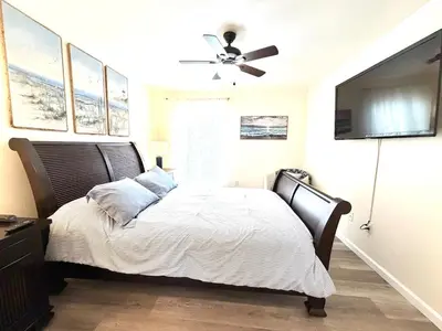 a bedroom with a bed and a ceiling fan at Bexley Blue in Panama City Beach