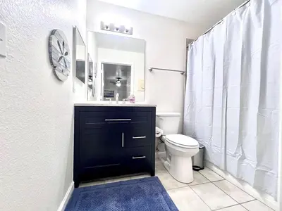 a bathroom with a black sink and a toilet at Bexley Blue in Panama City Beach
