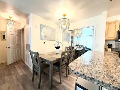 a kitchen and dining room with a table and chairs at Bexley Blue in Panama City Beach