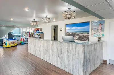 a lobby with a reception counter with a laptop on it at Bikini Beach Resort in Panama City Beach