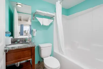 a bathroom with a toilet and a sink at Bikini Beach Resort in Panama City Beach