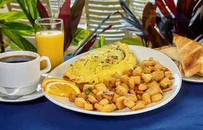 a plate of breakfast food with toast and orange juice at Holiday Inn Resort Panama City Beach by IHG in Panama City Beach
