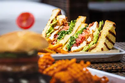 a sandwich and french fries on a plate at Holiday Inn Resort Panama City Beach by IHG in Panama City Beach