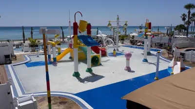 a playground at the beach with a slide at Holiday Inn Resort Panama City Beach by IHG in Panama City Beach