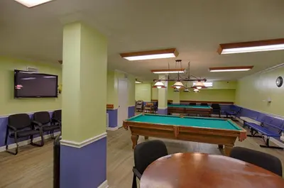 a billiard room with a pool table and chairs at Regency Towers by Panhandle Getaways in Panama City Beach