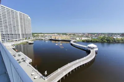 a bridge over a body of water next to a building at Laketown Wharf Resort by Panhandle Getaways in Panama City Beach