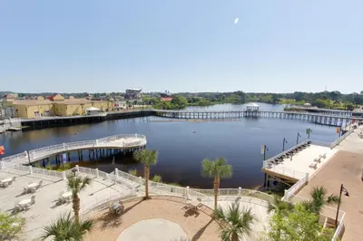 a large body of water with a pier and palm trees at Laketown Wharf Resort by Panhandle Getaways in Panama City Beach