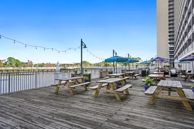 a group of picnic tables on a boardwalk at Laketown Wharf Resort by Panhandle Getaways in Panama City Beach