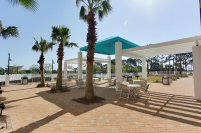 a pavilion with palm trees and a table and chairs at Laketown Wharf Resort by Panhandle Getaways in Panama City Beach