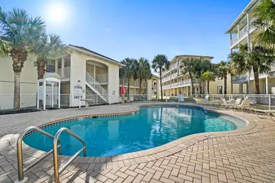 a swimming pool in the middle of a resort at Horizon South by Panhandle Getaways in Panama City Beach