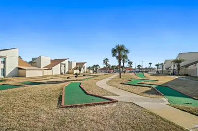 a row of green golf courses in a park at Horizon South by Panhandle Getaways in Panama City Beach