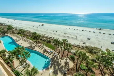 an aerial view of a beach with palm trees at Calypso 1-609 East in Panama City Beach