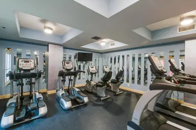 a gym with several cardio machines in a row at Calypso 1-609 East in Panama City Beach