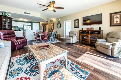 a living room with a couch and a table at Calypso 1-609 East in Panama City Beach