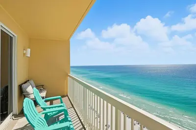 a balcony with two chairs and the ocean at Calypso 2-1907 West in Panama City Beach