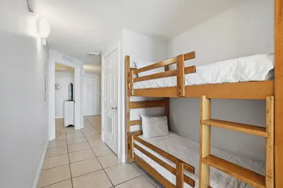 a hallway with two bunk beds in a room at Calypso 2-1907 West in Panama City Beach