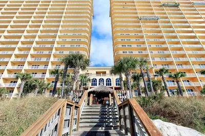 a staircase leading to a building with two tall buildings at Calypso 2-1907 West in Panama City Beach