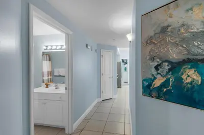 a bathroom with a large painting on the wall at Celadon 309 in Panama City Beach