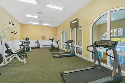 a gym with several treadmills and elliptical machines at Celadon 309 in Panama City Beach