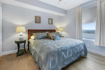 a bedroom with a bed and a large window at Grandview East 1203 in Panama City Beach