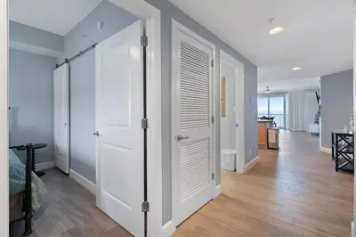 a room with white doors and a hallway at Grandview East 1203 in Panama City Beach