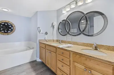a bathroom with two sinks and a mirror at Grandview East 1203 in Panama City Beach