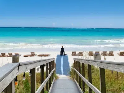 a person walking down a boardwalk to the beach at Grandview East 1203 in Panama City Beach