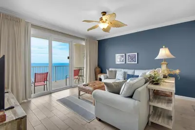 a living room with a couch and a ceiling fan at Grandview East 1204 in Panama City Beach