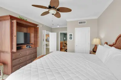 a bedroom with a bed and a ceiling fan at Grandview East 1204 in Panama City Beach