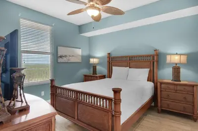 a bedroom with a bed and a ceiling fan at Grandview East 1204 in Panama City Beach