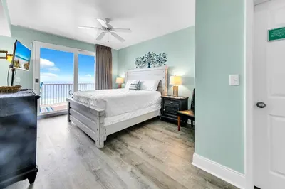 a bedroom with a bed and a view of the ocean at Laketown Wharf 1326 in Panama City Beach