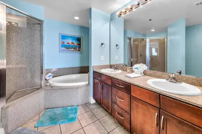 a bathroom with two sinks and a shower and a tub at Laketown Wharf 1326 in Panama City Beach