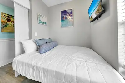 a bedroom with a large white bed in a room at Laketown Wharf 1326 in Panama City Beach