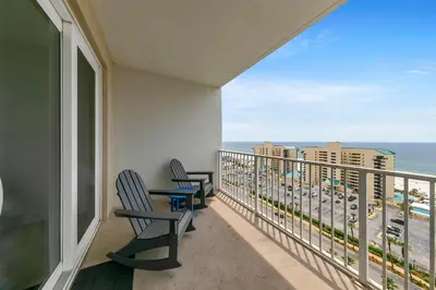 two chairs on a balcony with a view of the ocean at Laketown Wharf 1326 in Panama City Beach
