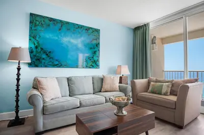 a living room with a couch and a table at Majestic Beach Towers 2-1905 in Panama City Beach