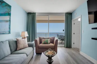 a living room with a couch and a chair at Majestic Beach Towers 2-1905 in Panama City Beach