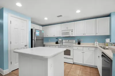 a kitchen with white cabinets and a white counter top at Majestic Beach Towers 2-1905 in Panama City Beach