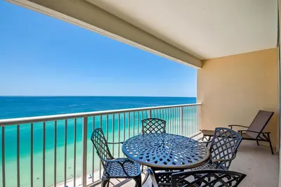 a table and chairs on a balcony with the ocean at Majestic Beach Towers 2-1905 in Panama City Beach