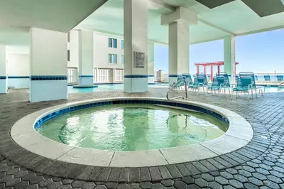 a pool in the middle of a building with chairs at Majestic Beach Towers 2-1905 in Panama City Beach